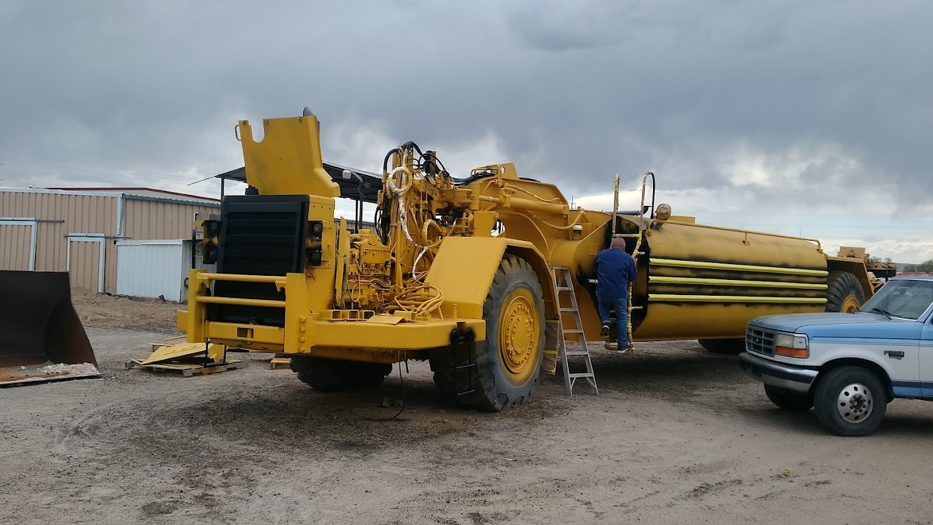 Field service team repairing heavy equipment on a job site